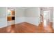 Open dining space with hardwood floors offering seamless flow to kitchen and stairway at 6033 Edinmeadow Ln, Charlotte, NC 28269