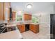 Well-lit kitchen with wood cabinets, and essential appliances, offering seamless flow to adjacent spaces at 6033 Edinmeadow Ln, Charlotte, NC 28269