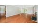 Hardwood floors in a spacious living room with fireplace and access to the backyard at 6033 Edinmeadow Ln, Charlotte, NC 28269