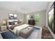 Serene main bedroom features neutral tones, multiple windows, and a ceiling fan for added comfort at 6033 Edinmeadow Ln, Charlotte, NC 28269