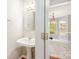 Quaint powder room featuring a pedestal sink and a view into the adjacent dining area at 6033 Edinmeadow Ln, Charlotte, NC 28269