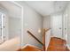 Stairwell with wood flooring and a white banister leading to the upper level of the home at 6033 Edinmeadow Ln, Charlotte, NC 28269