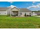 Backyard of home featuring a covered patio and spacious green lawn at 620 River Birch Dr, Salisbury, NC 28146