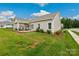 Backyard of home featuring covered patio, green lawn and sidewalk at 620 River Birch Dr, Salisbury, NC 28146