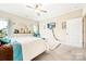 Bedroom with a queen bed, ceiling fan, dresser with mirror, and a lounge chair by a bright window at 620 River Birch Dr, Salisbury, NC 28146