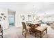 Open concept dining area with breakfast nook, chandelier, tile table with seating, and light-colored walls at 620 River Birch Dr, Salisbury, NC 28146