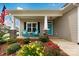 Inviting front porch with blue chairs and colorful landscaping at 620 River Birch Dr, Salisbury, NC 28146