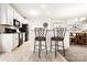 Bright kitchen features white cabinets, granite counters, stainless appliances, and breakfast bar with seating at 620 River Birch Dr, Salisbury, NC 28146