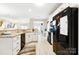 Open kitchen features granite countertops, white cabinets, and stainless steel appliances at 620 River Birch Dr, Salisbury, NC 28146