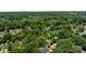 An aerial view highlights the homes nestled among lush trees within a quiet neighborhood at 6231 Coach Hill Ln, Charlotte, NC 28212