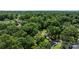 An aerial view showcases the homes situated among mature trees in the neighborhood at 6231 Coach Hill Ln, Charlotte, NC 28212