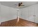 The bedroom is spacious with hardwood floors, a ceiling fan, and access to another room at 6231 Coach Hill Ln, Charlotte, NC 28212