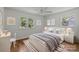 Well-staged bedroom with hardwood floors, a large window, and neutral paint, creating an inviting atmosphere at 6231 Coach Hill Ln, Charlotte, NC 28212