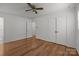 Spacious bedroom with hardwood floors, a ceiling fan, and a closet for storage at 6231 Coach Hill Ln, Charlotte, NC 28212