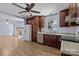 Open kitchen with dark cabinets, stainless steel appliances, and hardwood floors at 6231 Coach Hill Ln, Charlotte, NC 28212