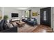 Modern living room featuring hardwood floors, neutral walls, and stylish furnishings at 6231 Coach Hill Ln, Charlotte, NC 28212