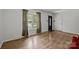 Bright living room features hardwood floors, a large window, and neutral paint, creating an inviting atmosphere at 6231 Coach Hill Ln, Charlotte, NC 28212