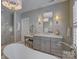 Bathroom featuring marble tile floors, a soaking tub, vanity and a large mirror at 628 Bracket St, Fort Mill, SC 29708