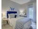 Bedroom with a large bed, white curtains, and bright blue artwork on the walls at 628 Bracket St, Fort Mill, SC 29708