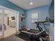 Home exercise room with a treadmill, rubber floor mats, and view into an adjacent bedroom at 628 Bracket St, Fort Mill, SC 29708