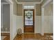 Elegant foyer with rich hardwood floors, decorative trim, and a welcoming front door at 628 Bracket St, Fort Mill, SC 29708