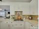 Bright kitchen features white cabinetry, stainless steel appliances, granite countertops and decorative tile backsplash at 628 Bracket St, Fort Mill, SC 29708