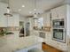 Bright open concept kitchen features white cabinetry, stainless steel appliances and granite countertops at 628 Bracket St, Fort Mill, SC 29708
