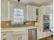 Bright kitchen features white cabinetry, stainless steel appliances, granite countertops and decorative tile backsplash at 628 Bracket St, Fort Mill, SC 29708