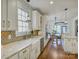Bright kitchen featuring white cabinets, granite countertops, and stainless steel appliances at 628 Bracket St, Fort Mill, SC 29708