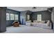 Stylish, moody living room with neutral carpet, a projector and a large sectional sofa at 628 Bracket St, Fort Mill, SC 29708