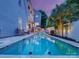 A stunning pool with cascading waterfall surrounded by lush landscaping and an outdoor seating area at 628 Bracket St, Fort Mill, SC 29708