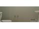 Bathroom with white toilet and sink against a neutral wall, accented by a chrome towel rack at 6298 Fairfax Ct, Maiden, NC 28650