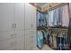Spacious walk-in closet with custom shelving, drawers, and hanging space for clothes at 630 Calvert St # 111, Charlotte, NC 28208
