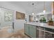 Stylish kitchen with an island featuring marble counters and stainless steel appliances, connected to a modernly decorated living room at 630 Calvert St # 111, Charlotte, NC 28208