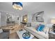 Bright living room featuring hardwood floors, modern lighting, and stylish decor at 630 Calvert St # 111, Charlotte, NC 28208