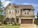 Beautiful two-story brick home with manicured lawn and an attached two-car garage under a canopy at 6510 Honeymeade Cir, Charlotte, NC 28277