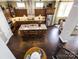 A bird's-eye view of the open kitchen with dark wood cabinets and hardwood floors at 6510 Honeymeade Cir, Charlotte, NC 28277