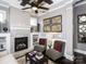 Bright living room with a fireplace, built-in shelving, comfortable seating, and large windows at 6510 Honeymeade Cir, Charlotte, NC 28277