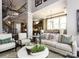 An open-concept living area with dark wood floors, stairs and kitchen views at 6510 Honeymeade Cir, Charlotte, NC 28277