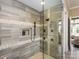 Modern shower showcasing gray tile, stonework accents, and stylish fixtures at 6510 Honeymeade Cir, Charlotte, NC 28277