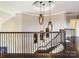 Spiral staircase featuring dark wood railing, hardwood floors, and pendant lighting at 6510 Honeymeade Cir, Charlotte, NC 28277