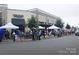 Large group of people gathered outside of the Tiffi Treate storefront at Waverly Place at 6510 Honeymeade Cir, Charlotte, NC 28277