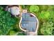 Aerial view showing a well maintained home with a patio, deck, and walkway in a wooded area at 6639 Camp Creek Rd, Lancaster, SC 29720
