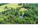 An aerial view of a secluded home nestled amidst verdant trees and expansive greenery offering privacy and scenic beauty at 6639 Camp Creek Rd, Lancaster, SC 29720