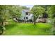 Spacious backyard with lush green lawn, mature trees, and black metal fencing at 6639 Camp Creek Rd, Lancaster, SC 29720