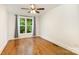 Comfortable bedroom featuring hardwood floors, a ceiling fan, and a large window offering natural light at 6639 Camp Creek Rd, Lancaster, SC 29720