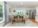 Dining area featuring hardwood floors, natural light, and a dining table for six at 6639 Camp Creek Rd, Lancaster, SC 29720