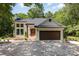 Charming painted-brick home featuring a two-car garage, and a welcoming front porch at 6639 Camp Creek Rd, Lancaster, SC 29720