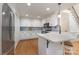 Modern kitchen with stainless steel appliances, white cabinets, and hardwood floors at 6639 Camp Creek Rd, Lancaster, SC 29720