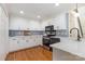 Bright kitchen features white cabinets, stainless steel appliances, and hardwood floors at 6639 Camp Creek Rd, Lancaster, SC 29720